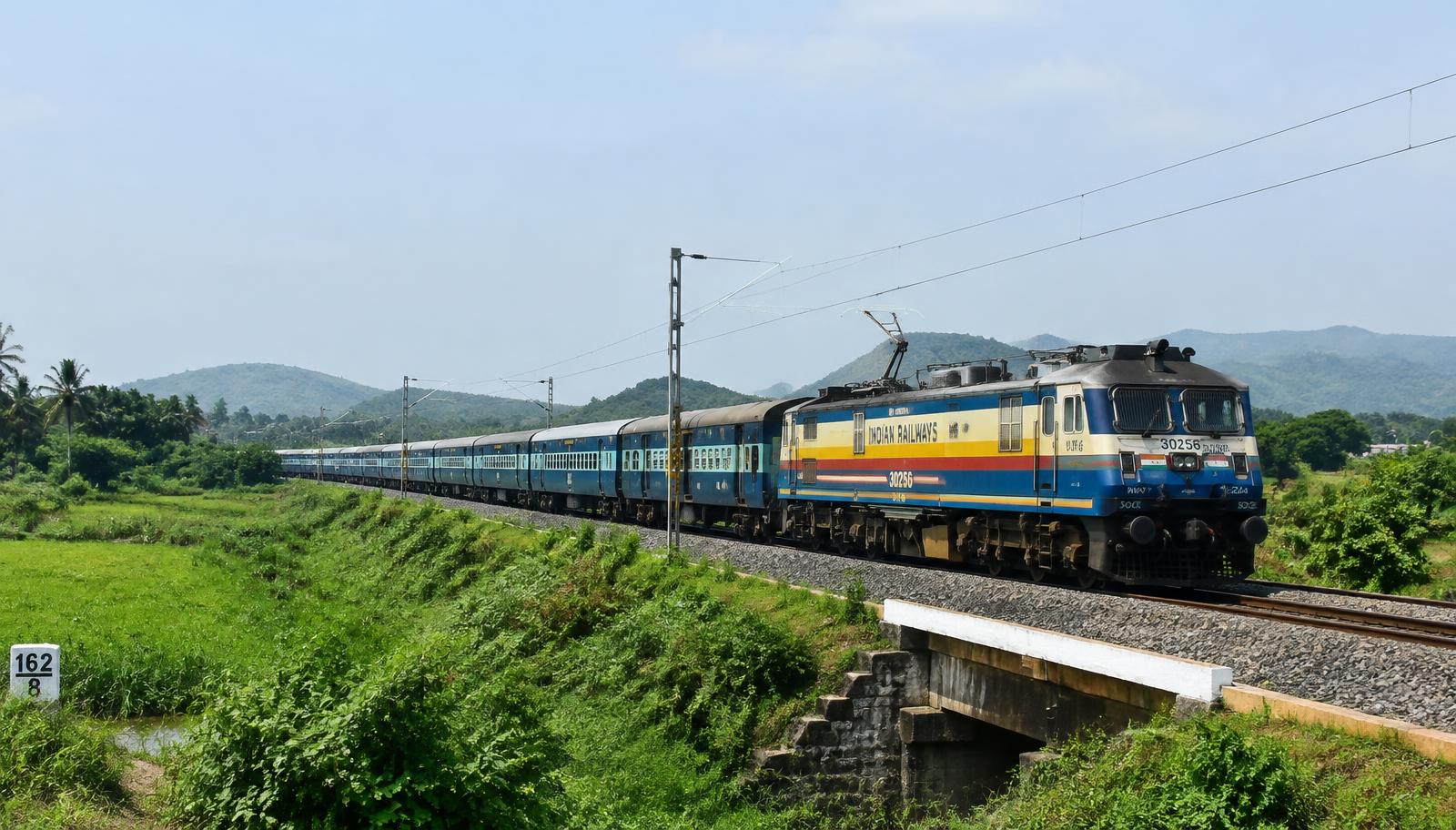 Indian Railways express train in green countryside